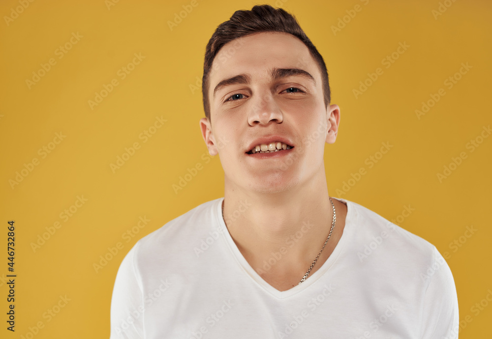 handsome man in white t-shirt confident look cropped view yellow background emotions handsome man in white t-shirt confident look cropped view yellow background emotions