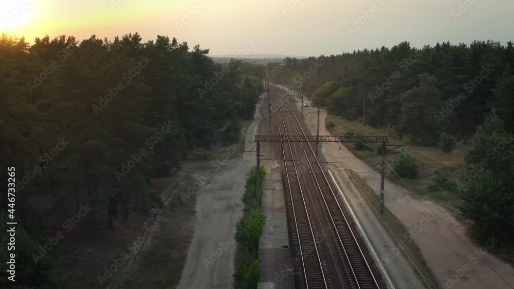 Shiny rails of an empty railway station. Suburban railway station with an empty apron, panoramic shot. Shiny rails of an empty railway station. Suburban railway station with an empty apron, panoramic shot.