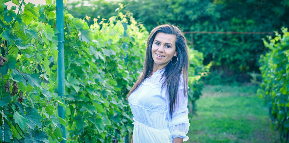 Young beautiful smiling woman walking at Vineyard Wine tourism Young beautiful smiling woman walking at Vineyard Wine tourism