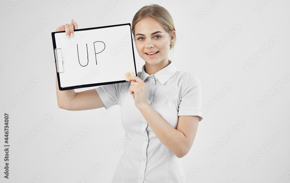 woman holding a folder with the inscription up cryptocurrency finance woman holding a folder with the inscription up cryptocurrency finance