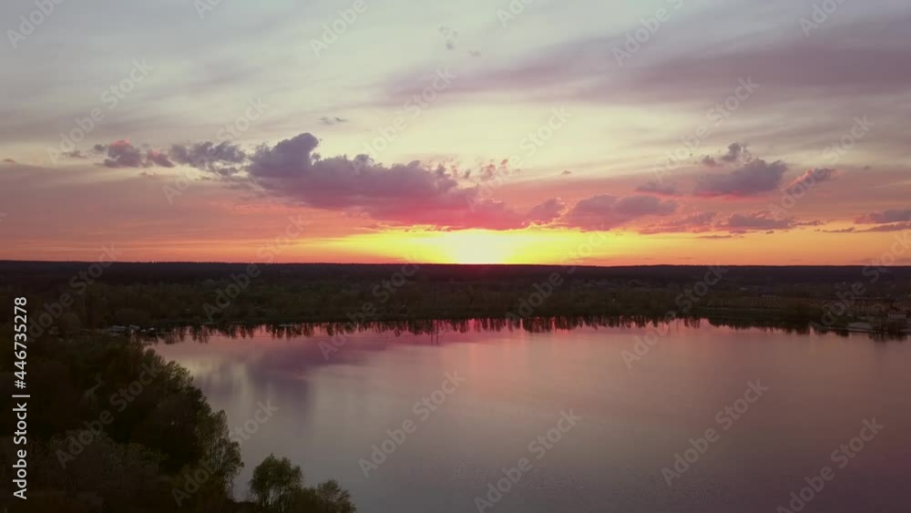 Beautiful sunset with clouds over the river under construction houses in the dark, Ukraine, Kiev on May 6. Beautiful sunset with clouds over the river under construction houses in the dark, Ukraine, Kiev on May 6.