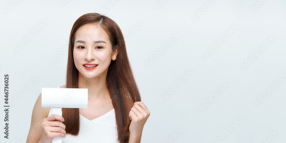 portrait of beautiful happy woman drying her long hair with dryer over white background portrait of beautiful happy woman drying her long hair with dryer over white background