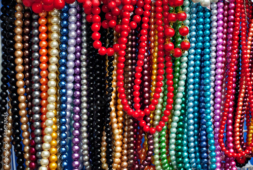 Necklace of colorful stones on the table. Many different jewelry and beads made of natural precious minerals. Beaded jewelry is on sale at the fair.