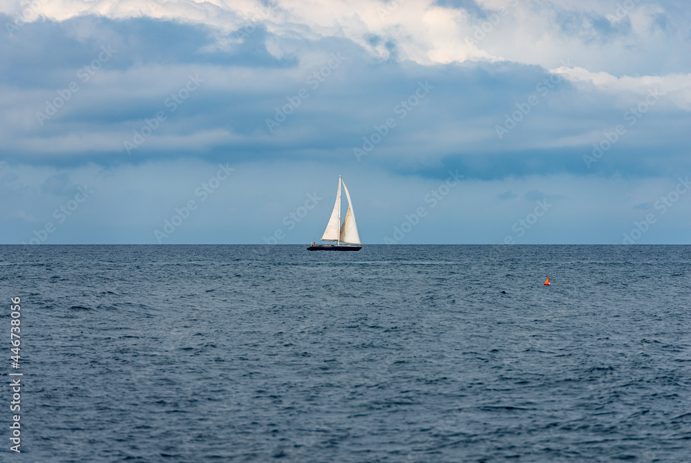 One sailing boat on the horizon on the mediterranean sea, Cinque Terre, Liguria, La Spezia, Italy, Europe.