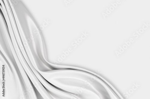 Beautiful elegant wavy silver white satin or grey silk luxury cloth fabric texture with monochrome background design. Copy space. 