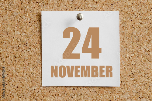 november 24. 24th day of the month, calendar date.White calendar sheet attached to brown cork board.Autumn month, day of the year concept