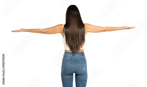 rear view of a young beautiful woman with outstretched arms