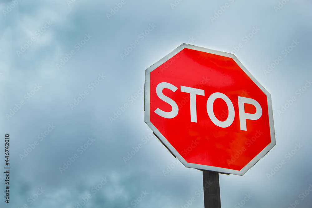 Stop sign on a dark sky background. 