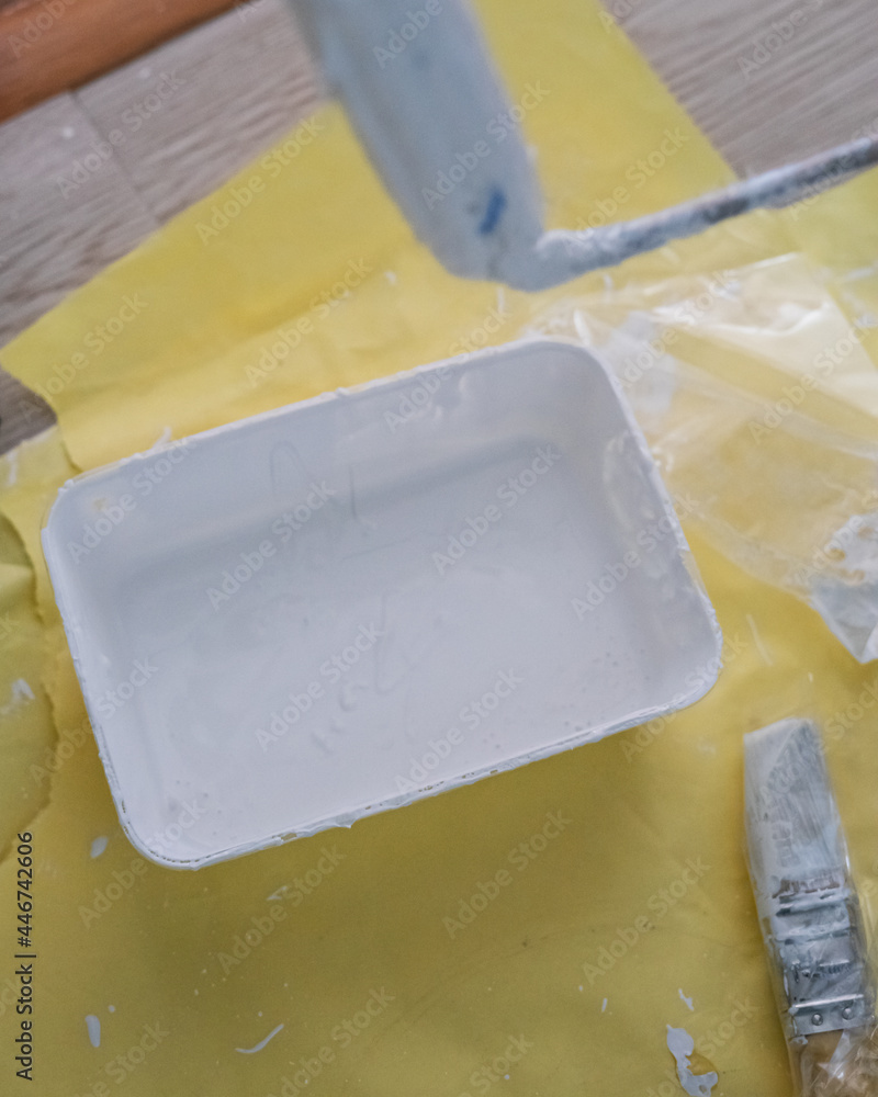 White paint in a container. Painting wall project. White paint in a container. Painting wall project.