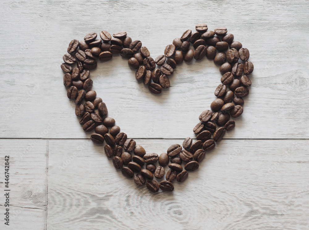 Coffee heart image copy space on white wood table top view and nature light and shadow cafe concept Coffee heart image copy space on white wood table top view and nature light and shadow cafe concept