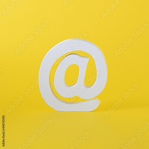 white word at for email and internet messages. word for on line comunication. yellow summer iluuminating background. virtual abstract art.