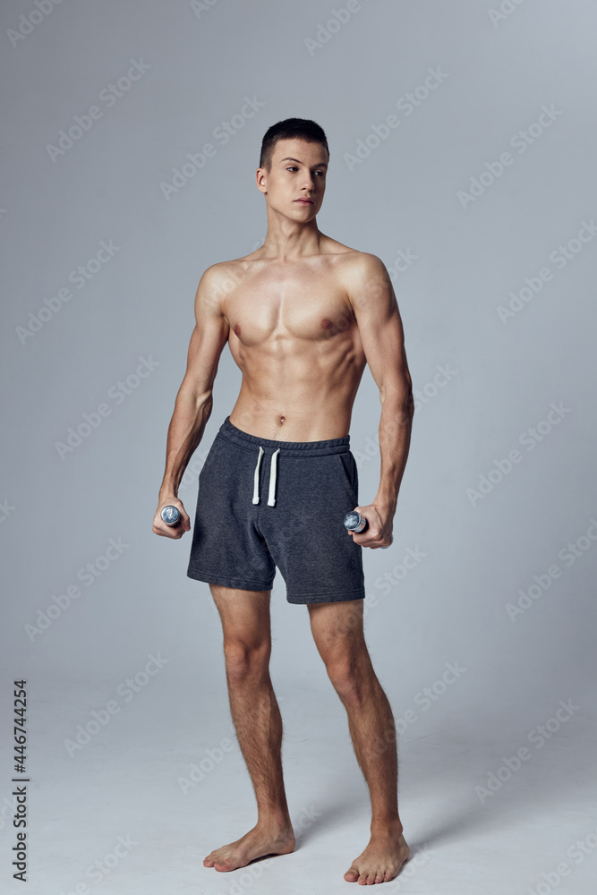 sporty man with pumped up muscular body gymnasium dumbbells in hands isolated background sporty man with pumped up muscular body gymnasium dumbbells in hands isolated background