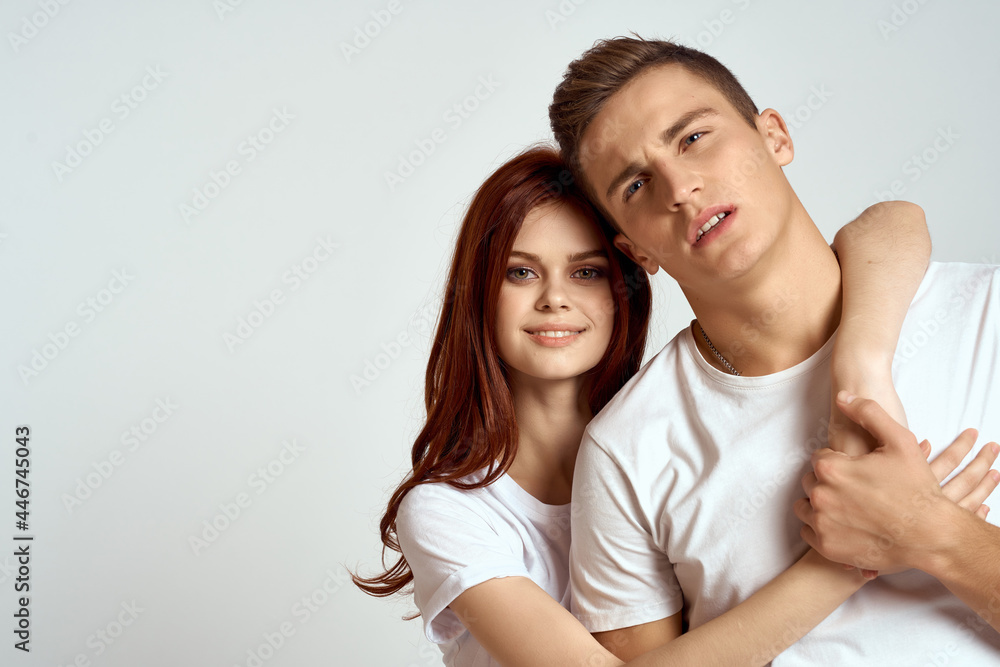 cheerful young couple in white t-shirts communication emotions lifestyle studio cheerful young couple in white t-shirts communication emotions lifestyle studio