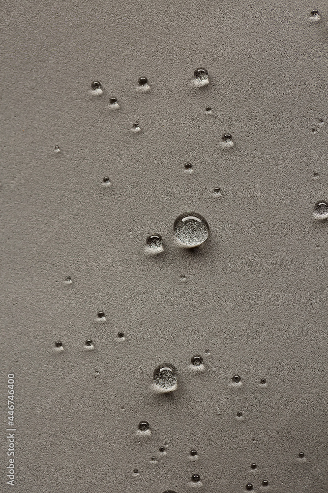 Round water drops on gray textured vertical background. Round water drops on gray textured vertical background.