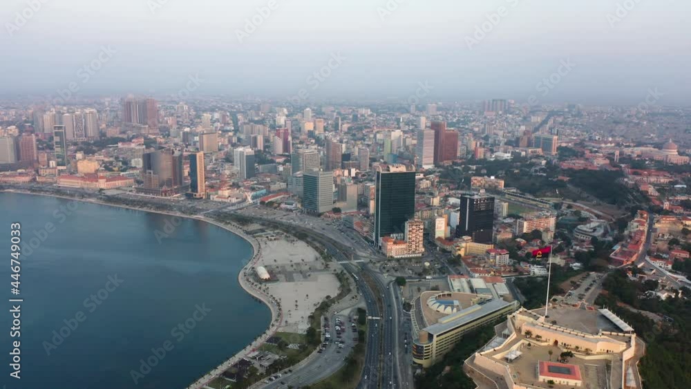 Reveal traveling back, Luanda city, golden hour flying over Luanda bay, Africa Reveal traveling back, Luanda city, golden hour flying over Luanda bay, Africa