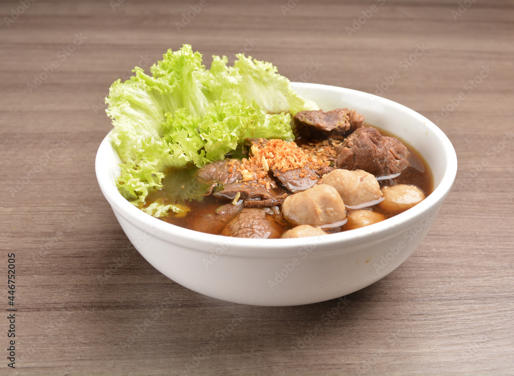 Vietnamese braised beef meat ball hot soup bowl in wood background asian halal menu Vietnamese braised beef meat ball hot soup bowl in wood background asian halal menu