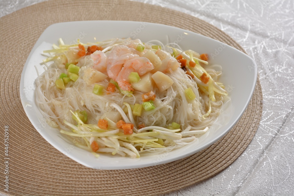 braised wok fried bee hoon vermicelli thin noodle with seafood prawn scallop and vegetables in chef white sauce in white background asian halal menu braised wok fried bee hoon vermicelli thin noodle with seafood prawn scallop and vegetables in chef white sauce in white background asian halal menu