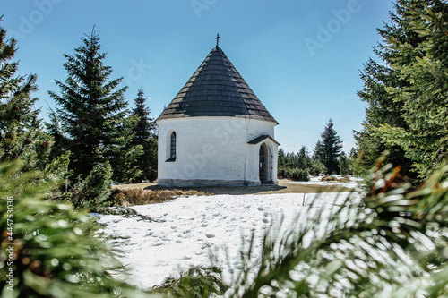 Baroque Chapel of the Visitation of the Virgin Mary,Kunstat Chapel, located in Eagle Mountains at altitude of 1035 m, Czech Republic.Circular floor plan and roof covered with shingles.Sunny day photo