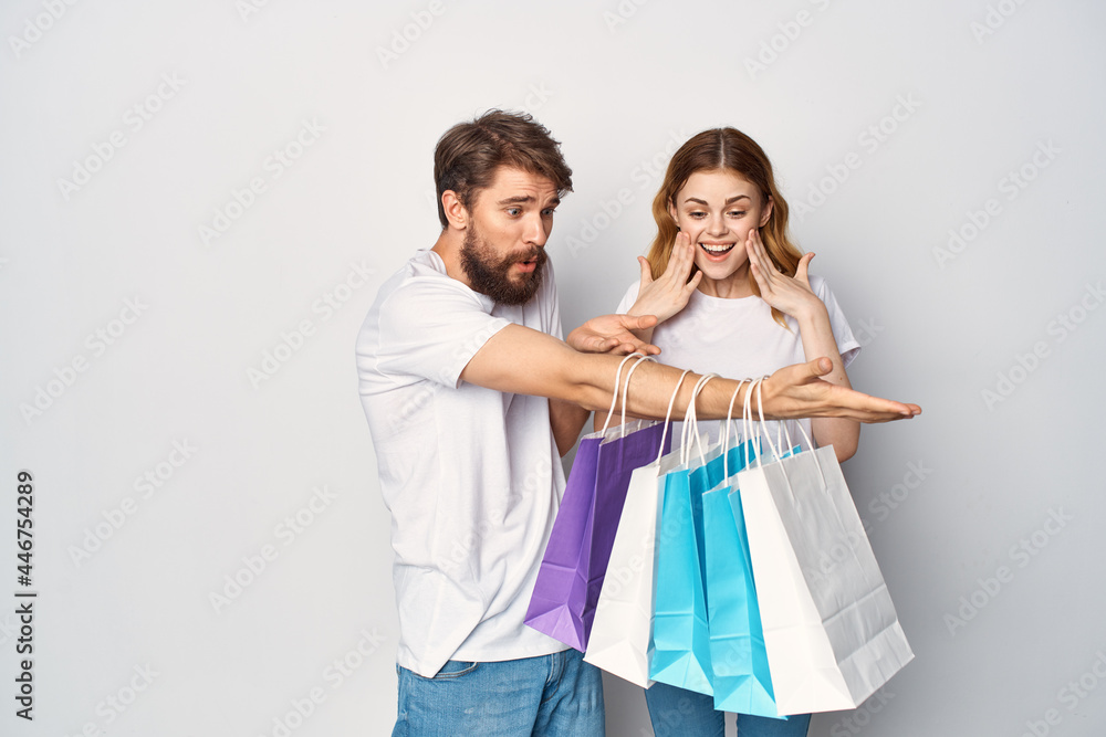 young couple in white t-shirts shopping discounts entertainment