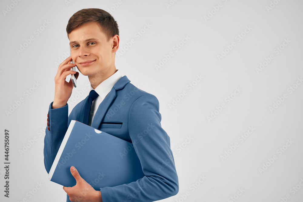 business man with documents in a suit talking on the phone office work business man with documents in a suit talking on the phone office work