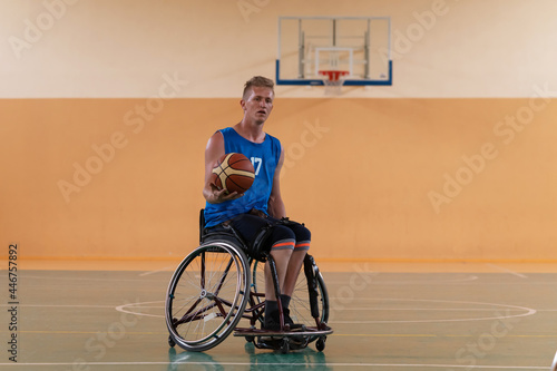 disabled war veterans in action while playing basketball on a basketball court with professional sports equipment for the disabled