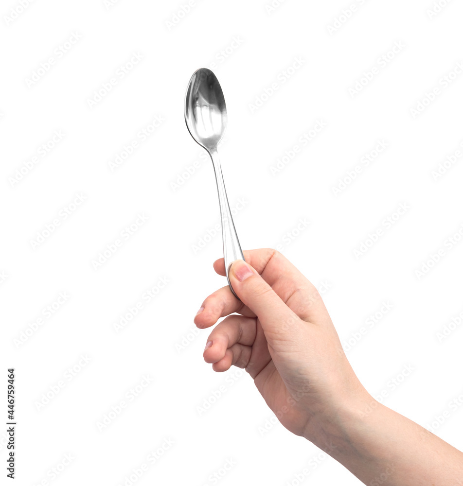 Steel shiny spoon in hand, isolated on a white background photo Steel shiny spoon in hand, isolated on a white background photo