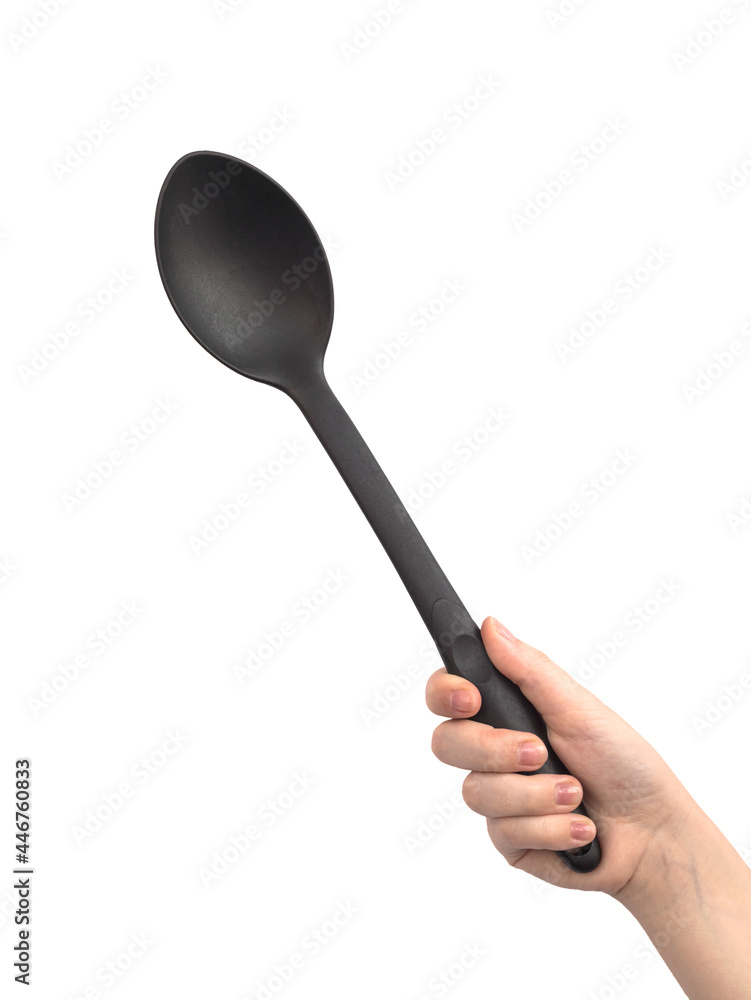 Black plastic ladle in hand, isolated on a white background photo Black plastic ladle in hand, isolated on a white background photo