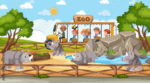 Safari at day time scene with many kids watching rhinoceros group