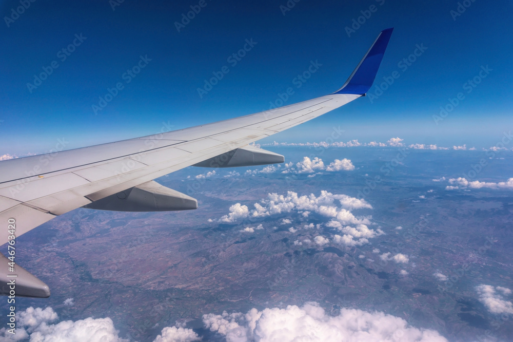 Wing of a passenger plane and the sky overboar. Summer trip Wing of a passenger plane and the sky overboar. Summer trip