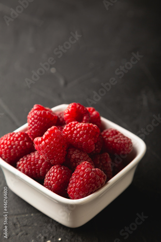Fresh raspberries on black table