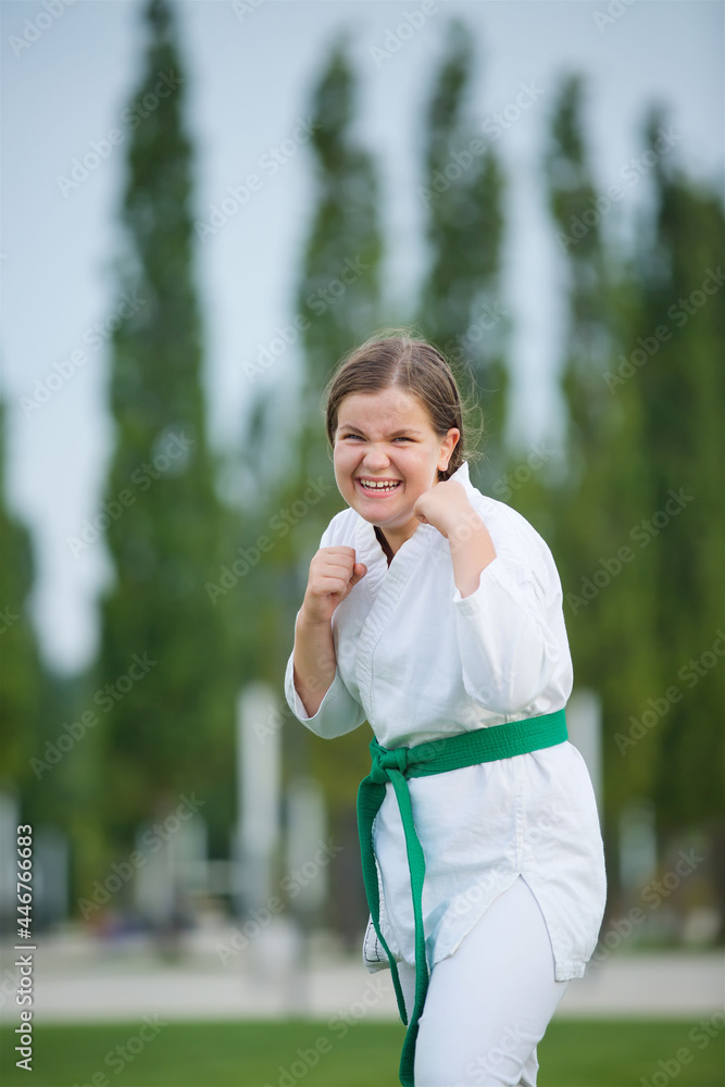Girl engaged in martial arts school age in kimono shows the elements of sports. Girl engaged in martial arts school age in kimono shows the elements of sports.