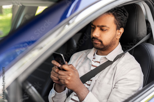 transport, people and technology concept - indian man or driver using smartphone in car © Syda Productions