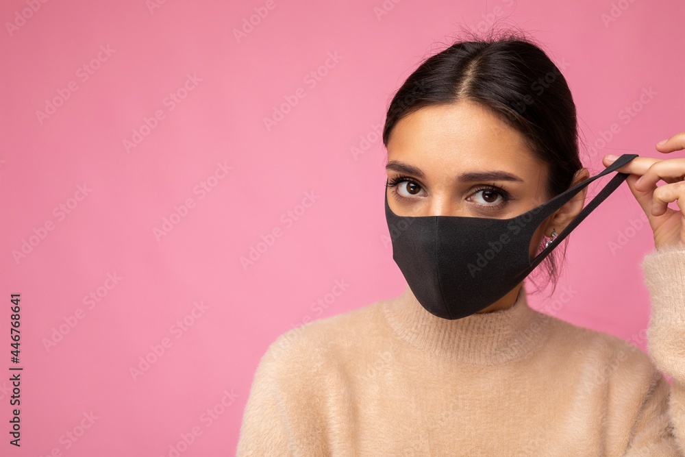 Photo of young attractive woman wearing handmade cotton fabric face mask isolated over colourful background wall. Protection against COVID-19 Photo of young attractive woman wearing handmade cotton fabric face mask isolated over colourful background wall. Protection against COVID-19