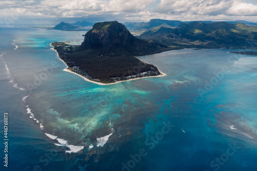 Tropical island with Le Morne mountain, ocean with waves and beach in Mauritius. Aerial view