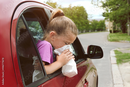 Obraz na płótnie Little girl with paper bag suffering from nausea in car