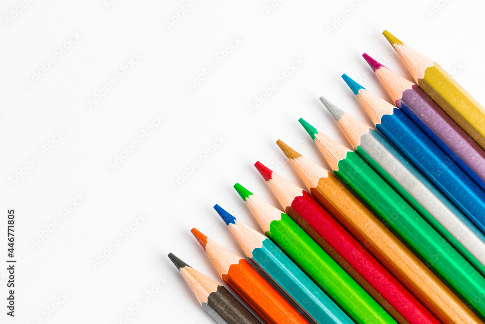 Color wooden pencils isolated on white background. Multi-colored palette for drawing, place for text. Color wooden pencils isolated on white background. Multi-colored palette for drawing, place for text.