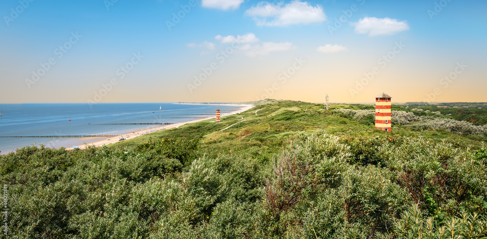 Panoramic coastal landscape with lighthouse in the dunes at the beautiful beach of Dishoek, Zeeland, The Netherlands.