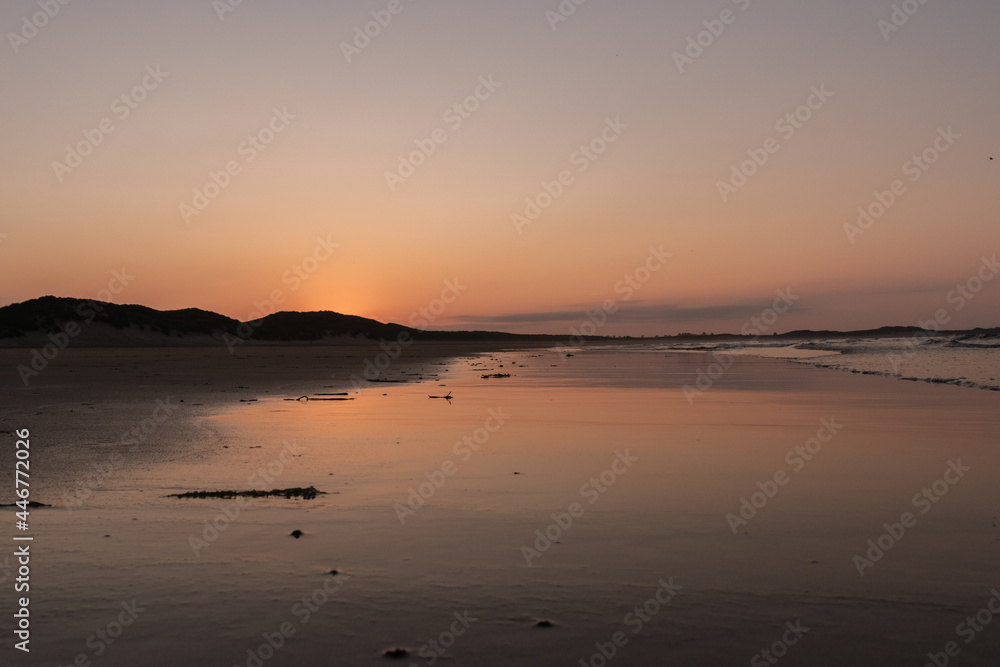 Sunset on the beach reflecting the light off the beach Sunset on the beach reflecting the light off the beach