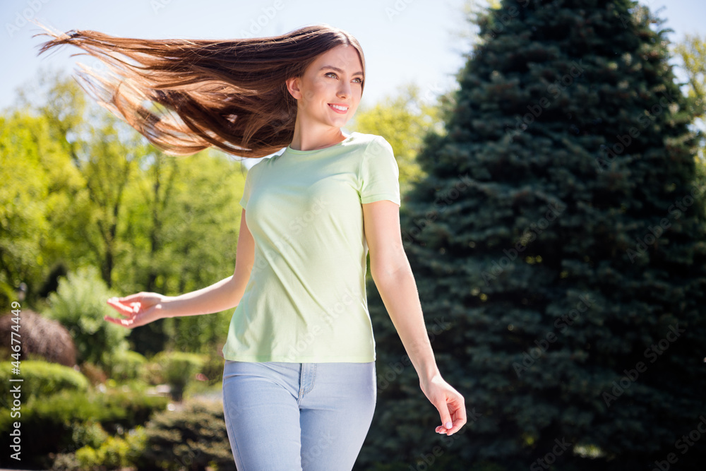 Photo of shiny sweet woman wear green clothes smiling walking wind blowing outdoors urban city park Photo of shiny sweet woman wear green clothes smiling walking wind blowing outdoors urban city park