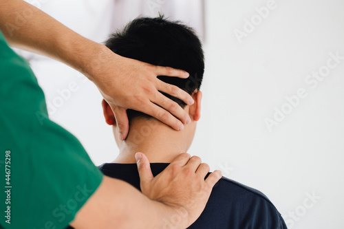 Konstfotografi physiotherapist massage therapist holding male client's head and massaging tight neck muscles the result of prolonged use of mobile phones