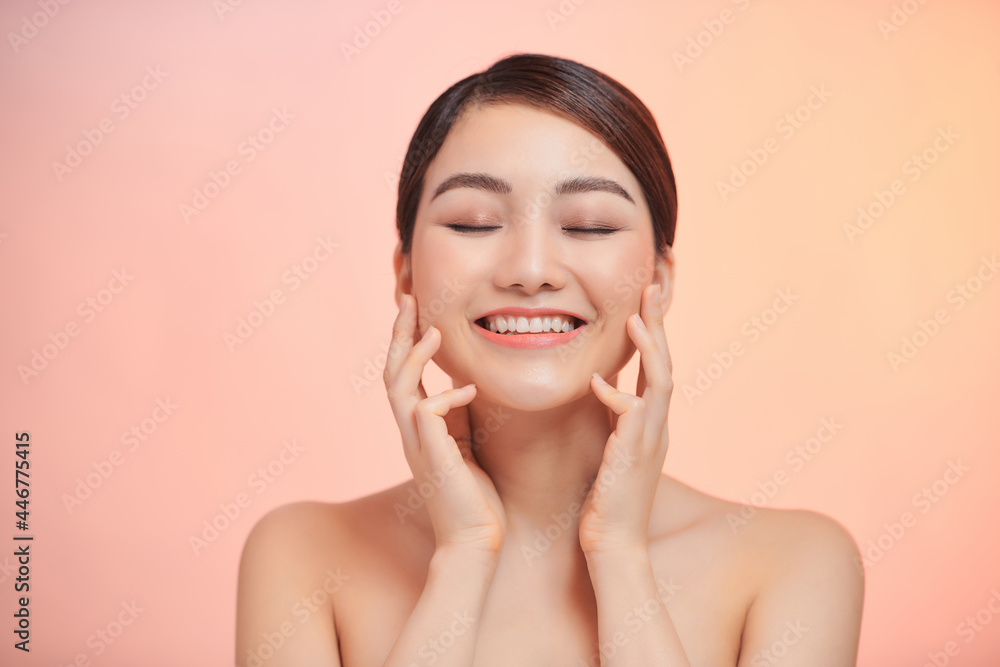 Female portrait with bare shoulders on a biege background Female portrait with bare shoulders on a biege background