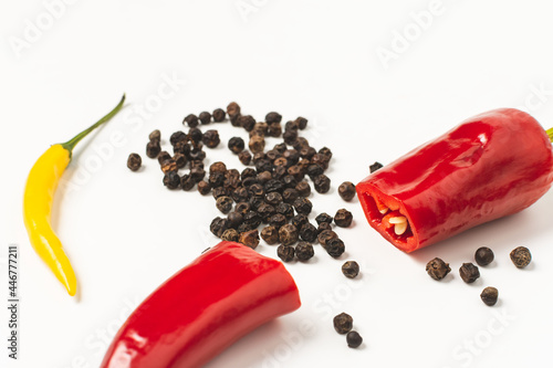 red hot peppers and dried peppercorns on a white background