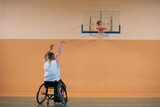 a photo of a war veteran playing basketball with a team in a modern sports arena. The concept of sport for people with disabilities