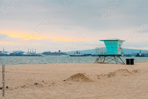 Sandy beach on the beach in Los Angeles, blue towers of lifeguards at sunset on the California coast