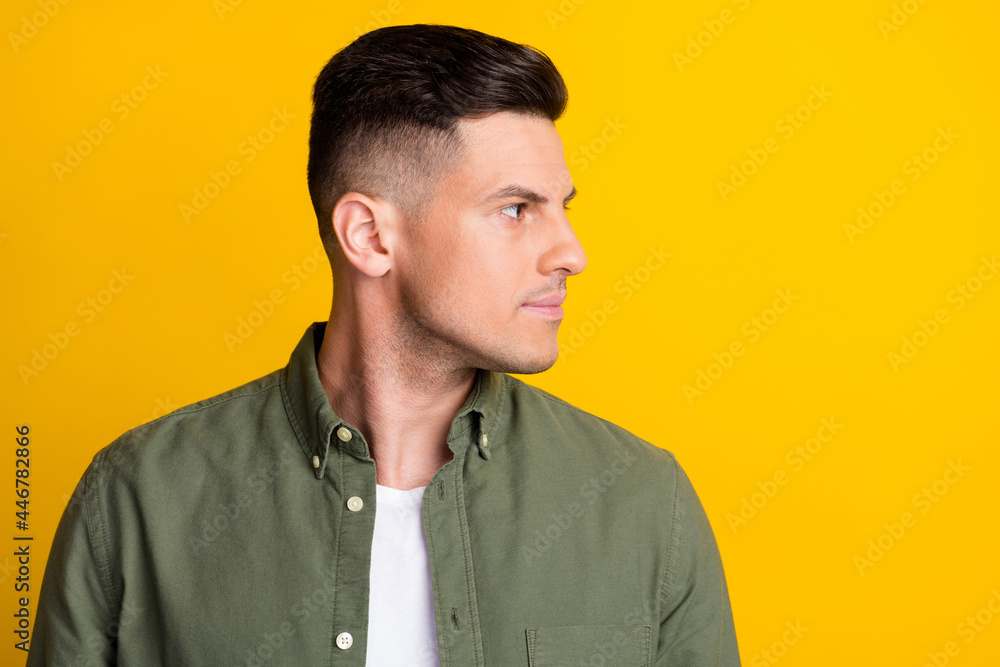 Side profile photo portrait man confident looking copyspace in green shirt isolated vivid yellow color background Side profile photo portrait man confident looking copyspace in green shirt isolated vivid yellow color background