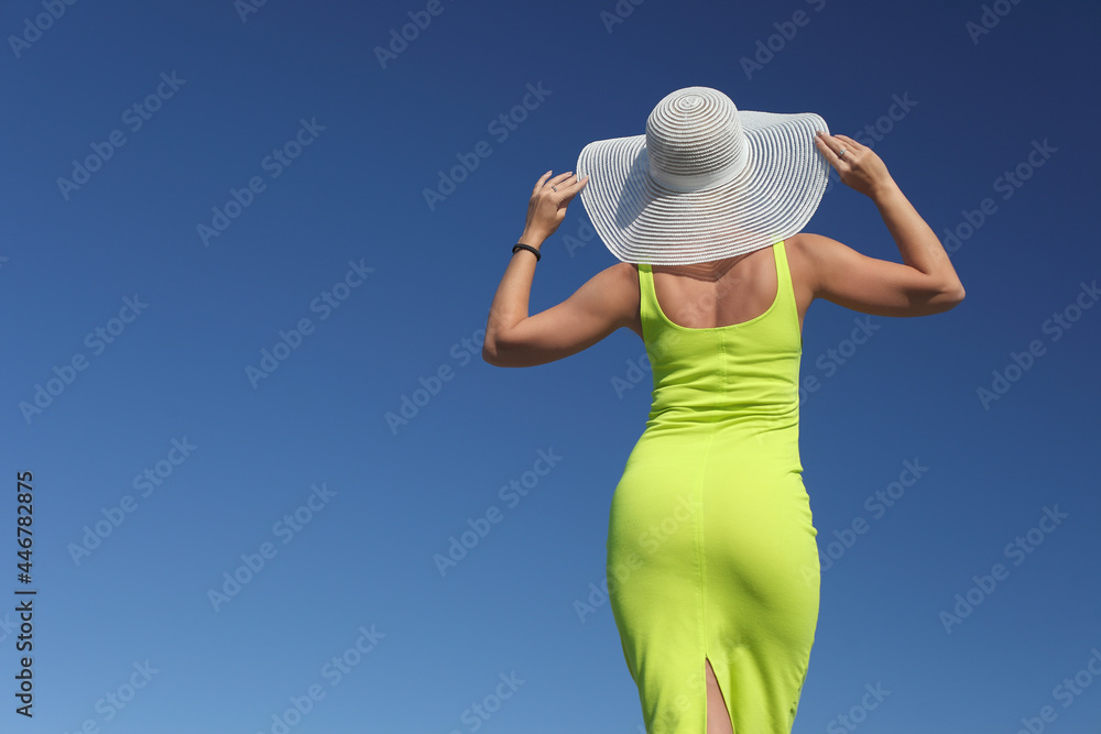 young girl in a dress and a summer hat