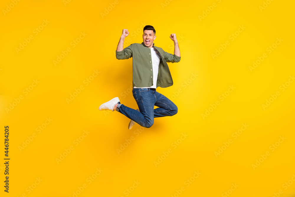 Full length body size photo guy jumping up gesturing like winner isolated vibrant yellow color background