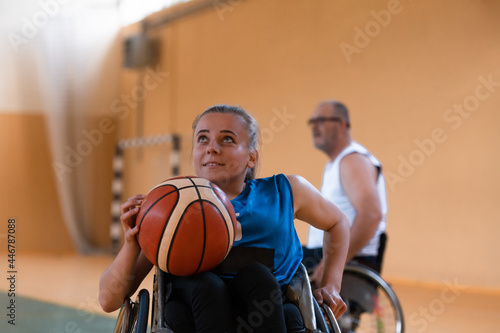 a young woman playing wheelchair basketball in a professional team. Gender equality, the concept of sports with disabilities.  © .shock