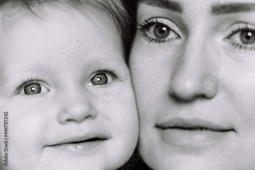 black and white close up portrait of young caucasian woman and baby daughter