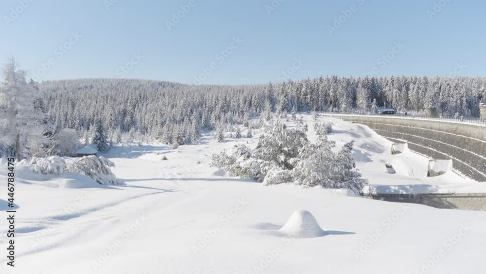 Snow-covered landscape with a forest - view from a slope Snow-covered landscape with a forest - view from a slope